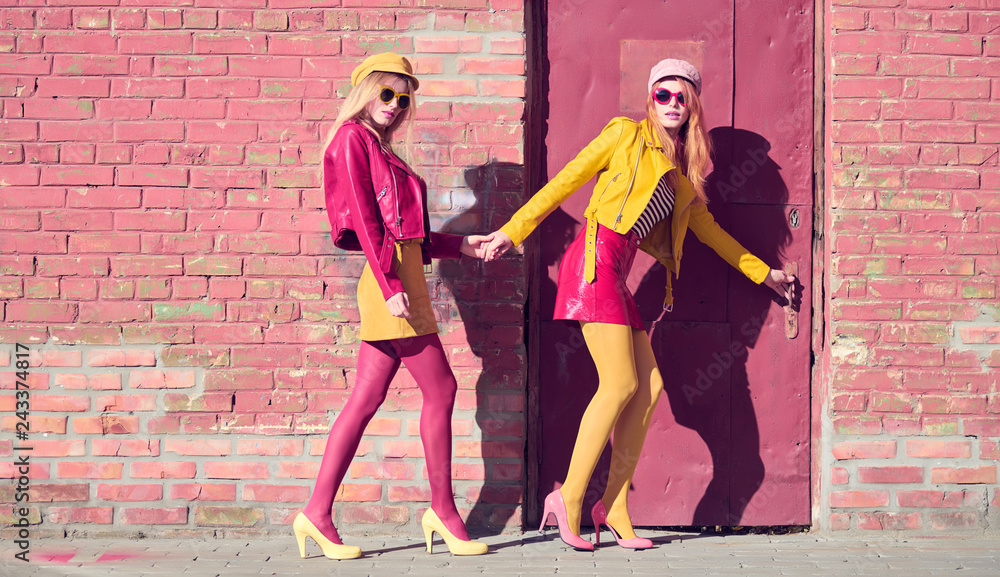 Urban fashion. Two Girl in Trendy colorful Outfit walking wearing