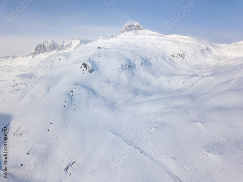 Aerial view of snow covered mountains in Swiss alps. Beautiful panorama of wild and tranquil backcountry in alpine area. © Mario