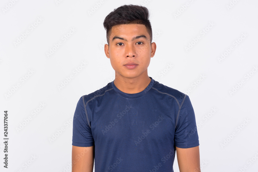 Young Asian man looking at camera against white background Young Asian man looking at camera against white background