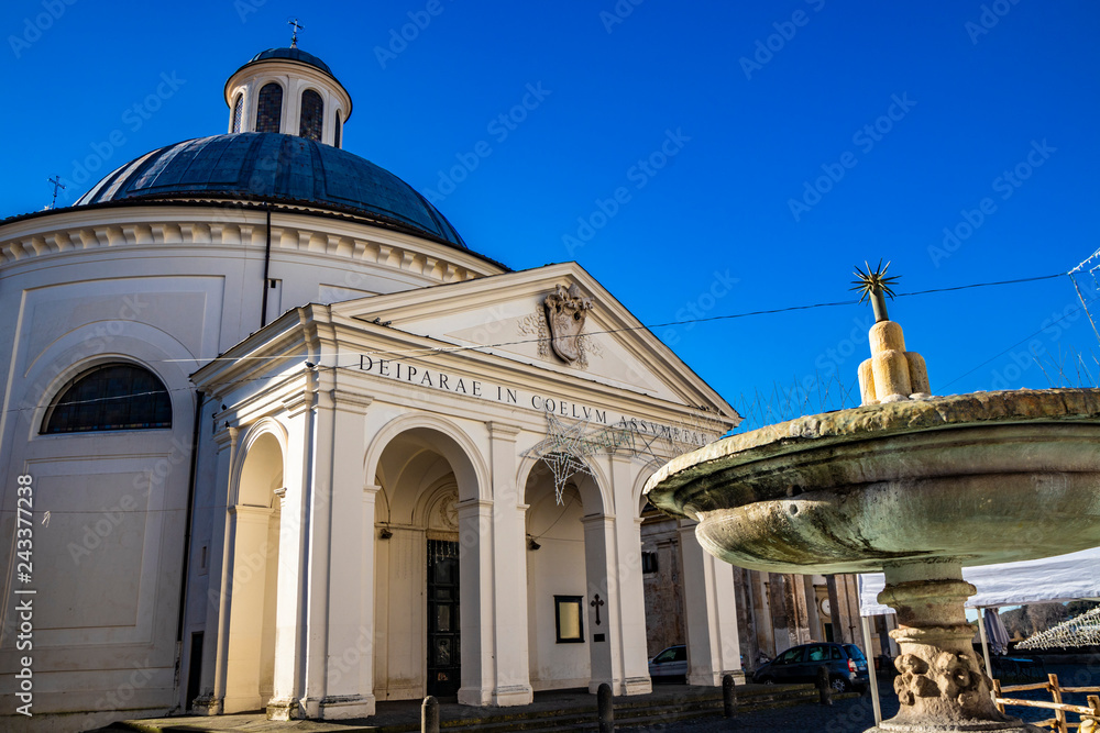 the church of Santa Maria Assunta, in the monumental Piazza di Corte, by Gian Lorenzo Bernini and the Chigi family. The dome, the bell tower and the fountain. Ariccia, Castelli Romani, Lazio, Italy.