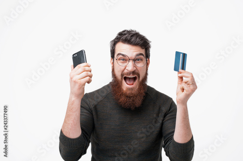 Stylish bearded hipster is excited for his bank acount photo