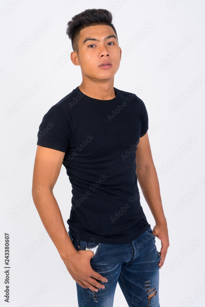 Young Asian man looking at camera against white background Young Asian man looking at camera against white background