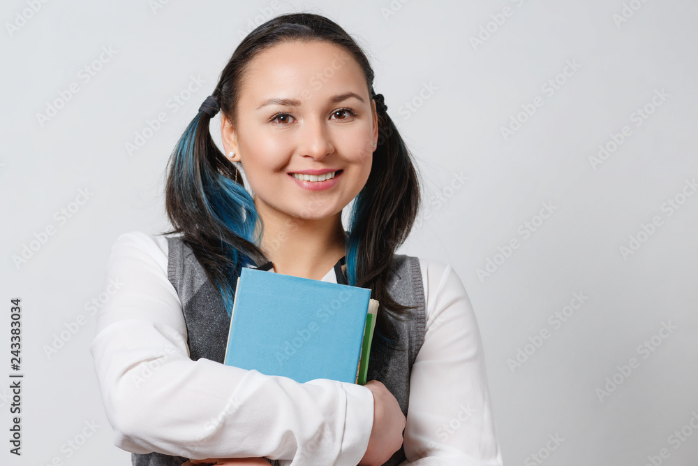 A young girl is a student of a high school student with a stack of textbooks in her hands. on white background A young girl is a student of a high school student with a stack of textbooks in her hands. on white background