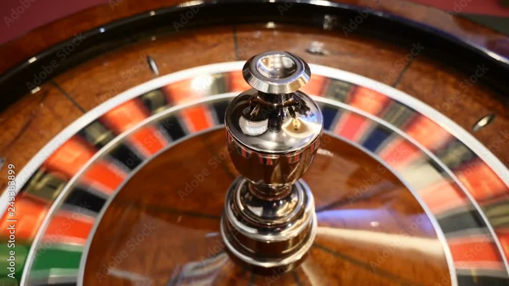 Casino theme. Top view on roulette in motion, white ball spinning. Bad luck and Good luck concept. Roulette wheel running. City nightlife entertainment. hd Casino theme. Top view on roulette in motion, white ball spinning. Bad luck and Good luck concept. Roulette wheel running. City nightlife entertainment. hd