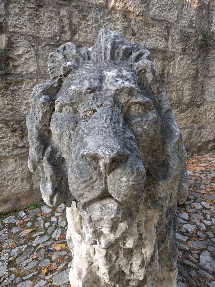 Close up view of an ancient lion sculpture in the Castle of Brescia, Lombardy, Italy.