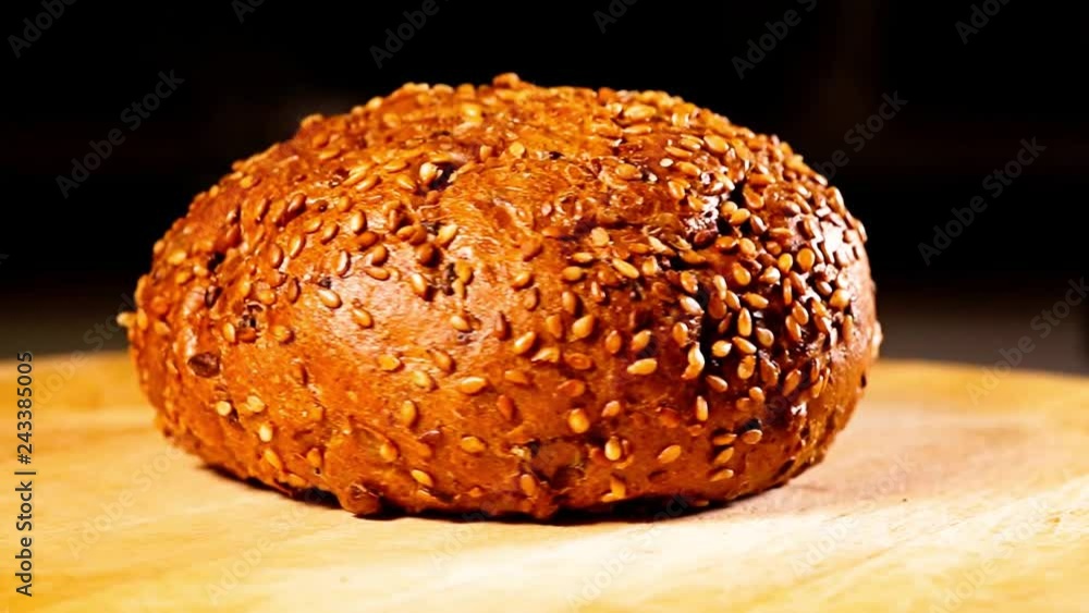 Burger bun with sunflower seeds rotating on white background Burger bun with sunflower seeds rotating on white background