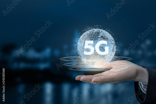 A hand is holding a digital sphere with 5G sign inside.