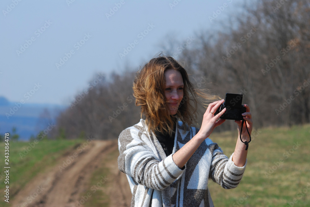 happy woman photographing herself outdoors