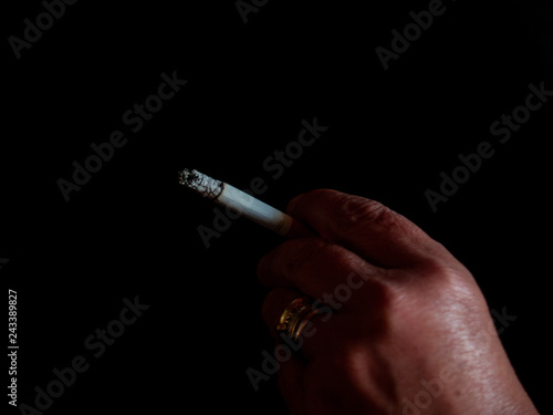 The hand of a woman smoking a cigarette © anuskiserrano