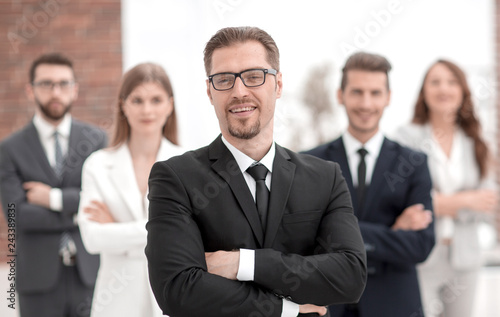 confident businessman in front of his business team.