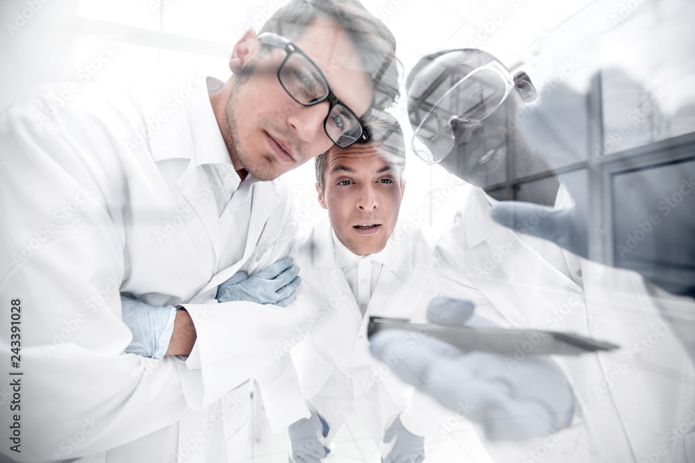 close up.a group of scientists discussing the results of the experimen close up.a group of scientists discussing the results of the experimen