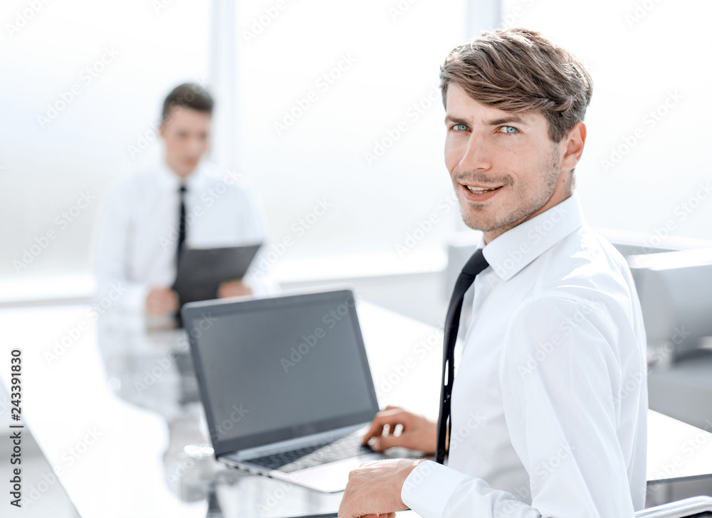 rear view.successful businessman sitting at the office Desk rear view.successful businessman sitting at the office Desk