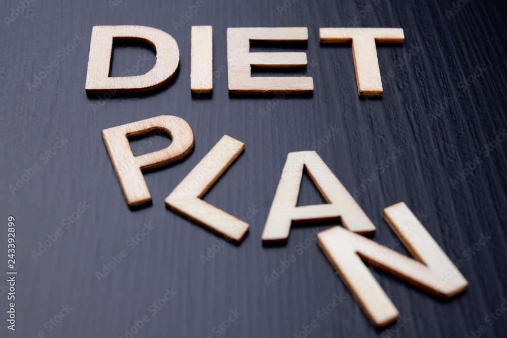 The inscription is arranged from letters cut out of wood on the table. The word diet plan.