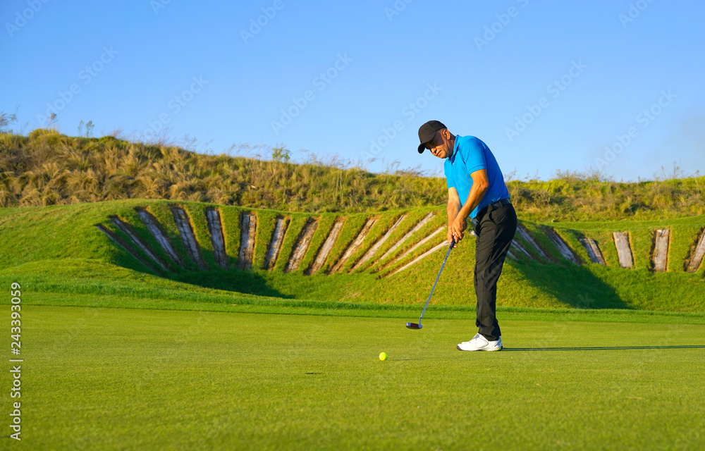 Fototapeta premium Golf player is swinging at links golf course