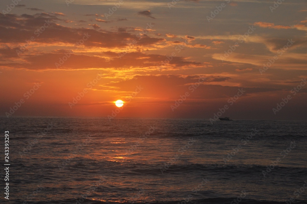 Sunset over the ocean with boat Sunset over the ocean with boat