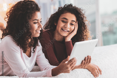 Caring sister showing her sibling memorable photos