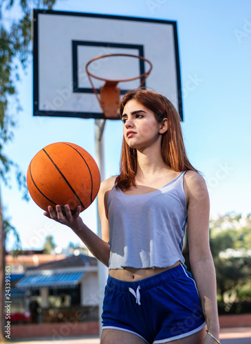 Young woman enjoys on the basketball court with her ball © lymdigital