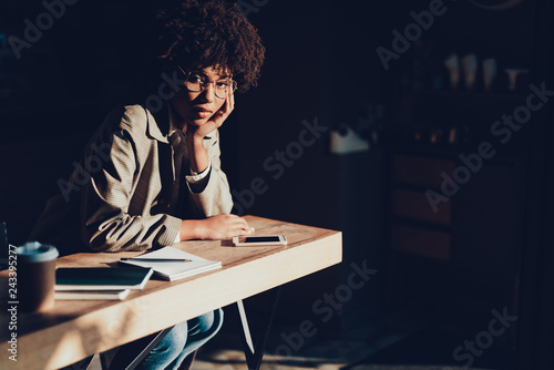 Woman sitting in cafe after long work day