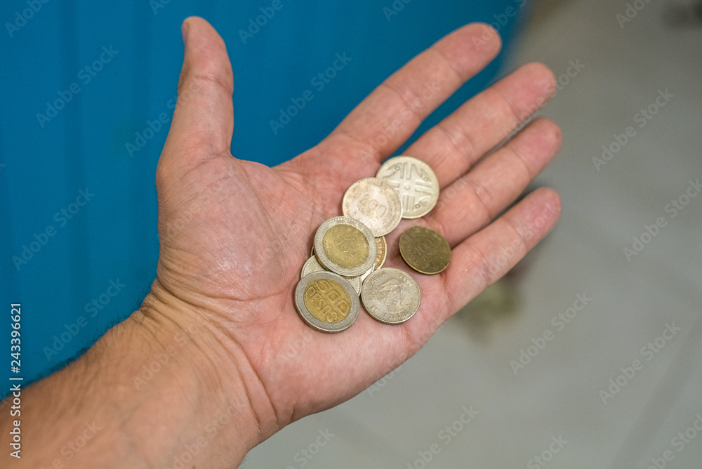 hand holding colombian banknotes of thousands of pesos, different cash value hand holding colombian banknotes of thousands of pesos, different cash value