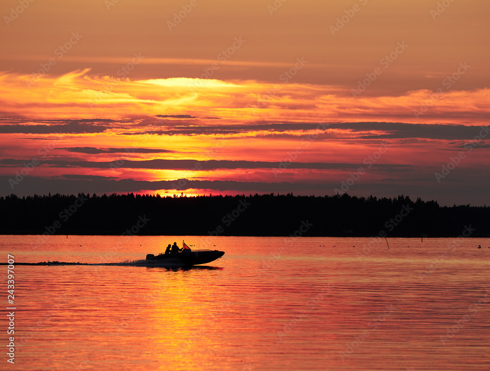 A fishing boat on a lake in sunset scene