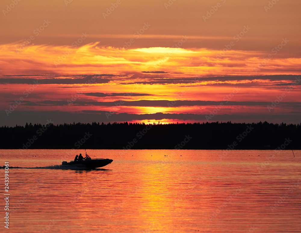 A fishing boat on a lake in sunset scene