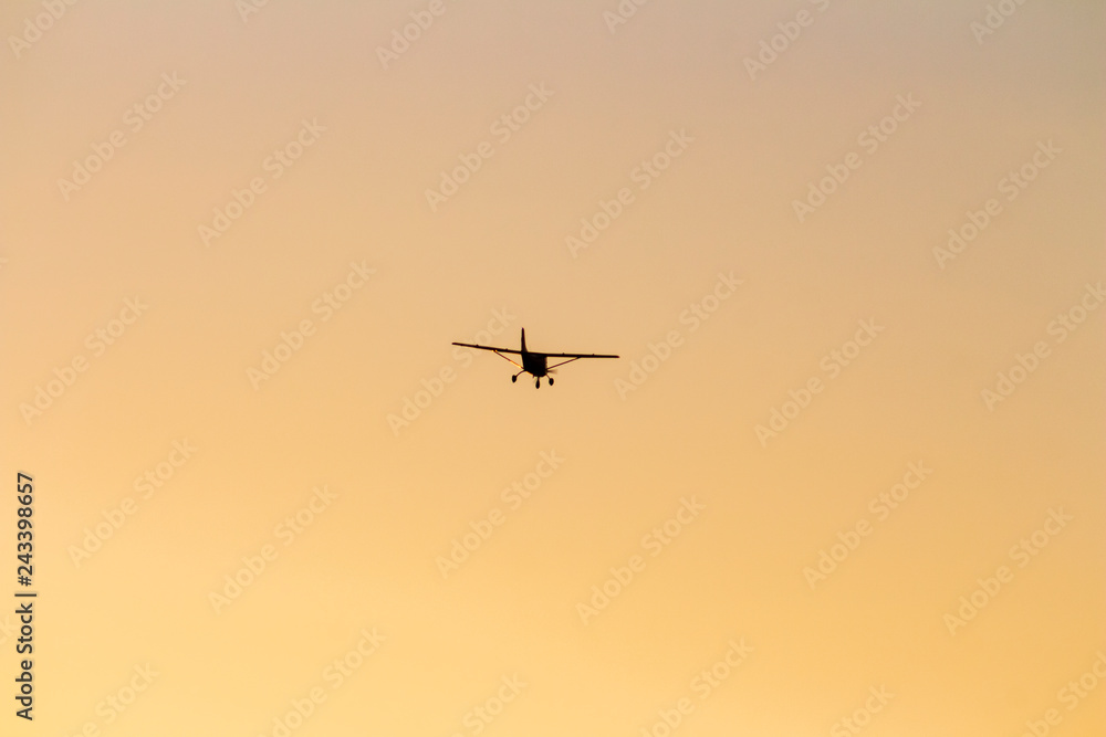 small airplane flying at sunset small airplane flying at sunset