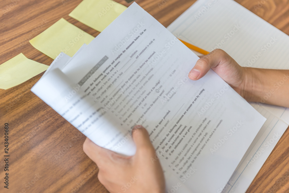 Obraz premium Close-up of student hands holding workbook and self studying