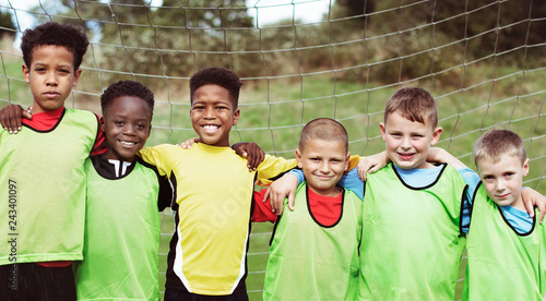 Happy junior football team standing together photo