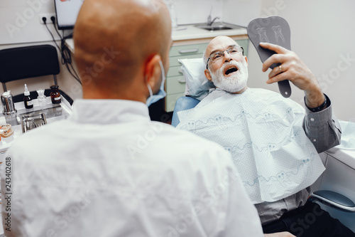 Old man sitting in the dentist's office