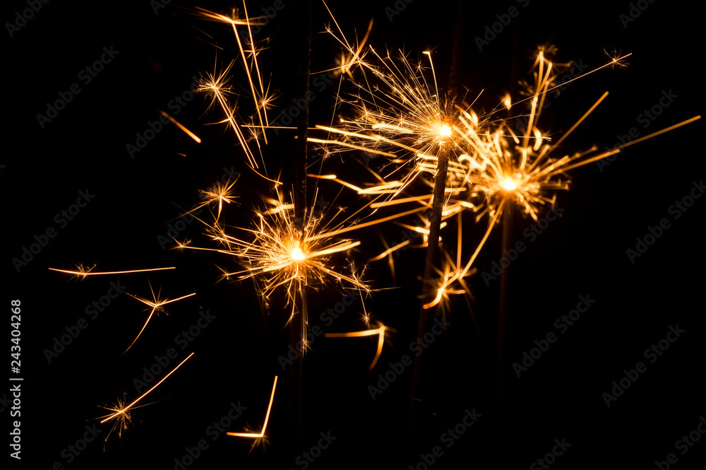 Light sparklers on holiday glare sparks texture background