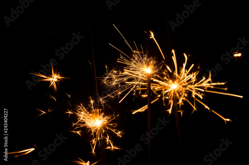 Light sparklers on holiday glare sparks texture background