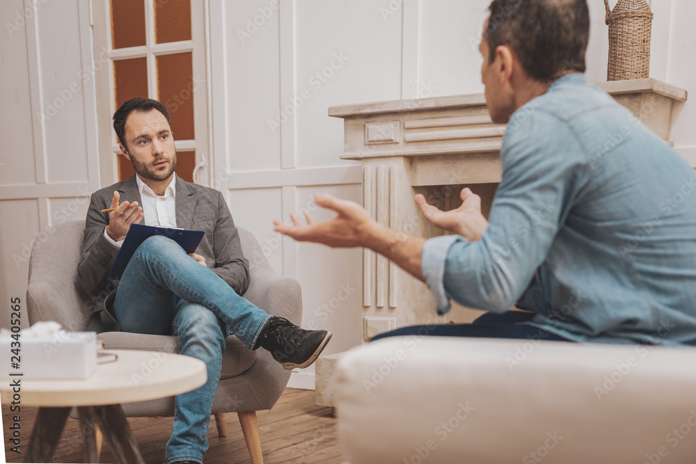 Dark-eyed qualified therapist giving treatment Dark-eyed qualified therapist giving treatment