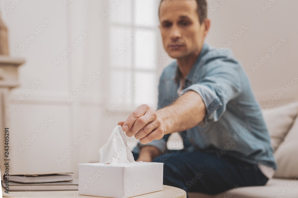 Stressed perplexed man taking napkin from the table Stressed perplexed man taking napkin from the table