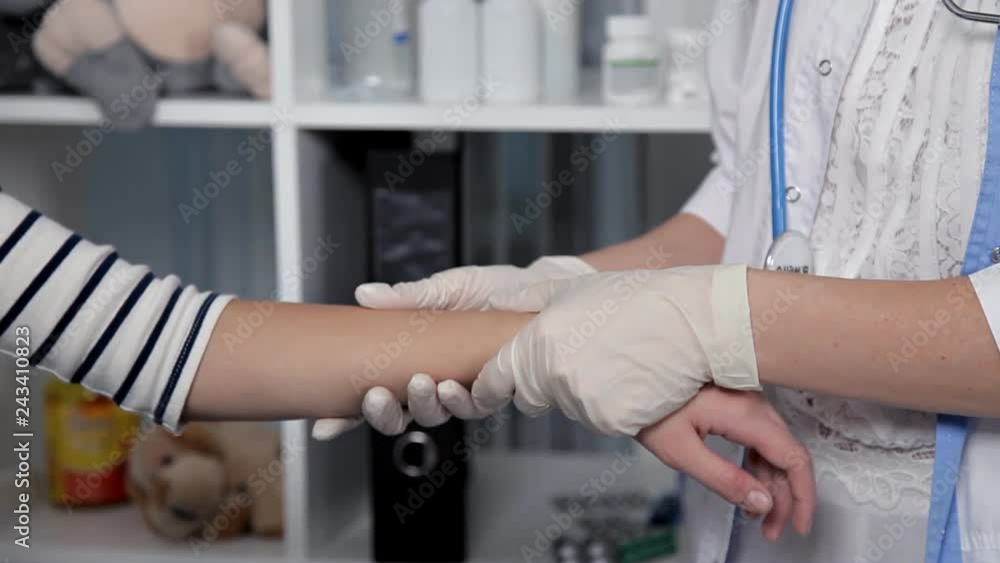 A young doctor examines a patient, child, in his office A young doctor examines a patient, child, in his office