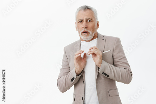 Bild auf Leinwand Portrait of intense displeased old male man in elegant suit holding hands presse