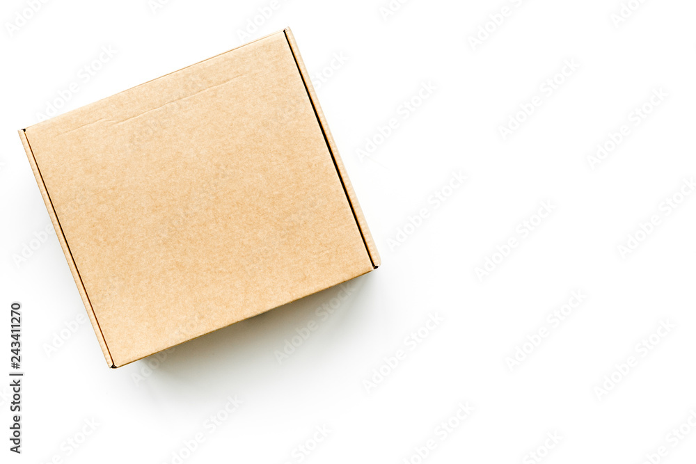 Delivery concept. Cardboard box on white background top view mockup Delivery concept. Cardboard box on white background top view mockup