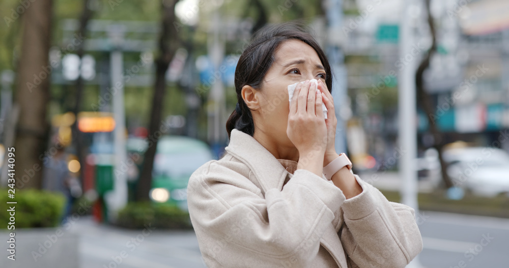 Fototapeta premium Woman sneeze in the city