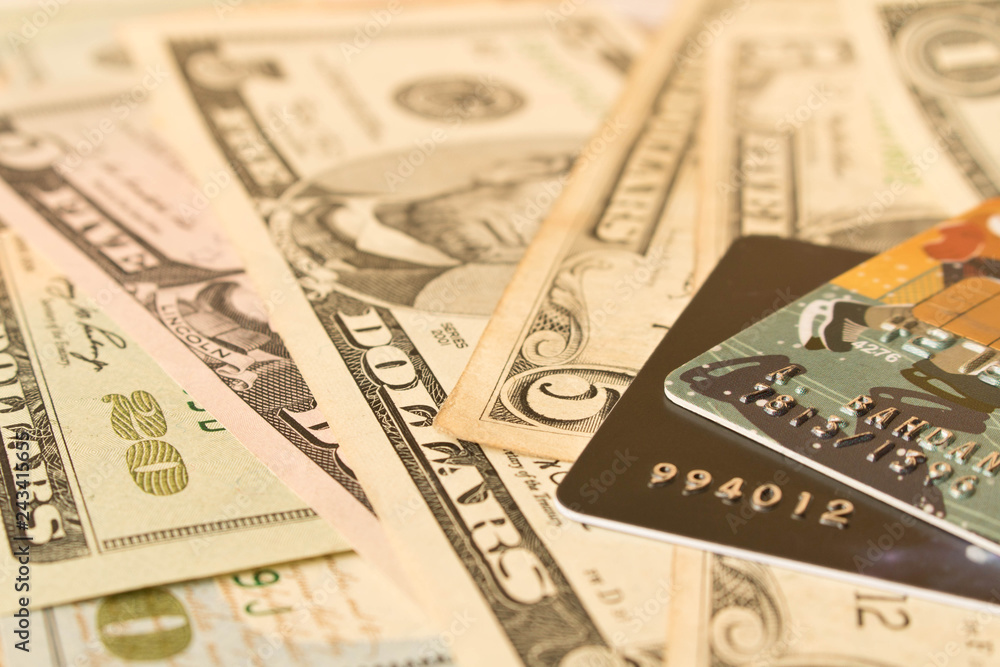 Credit cards and cash dollars. The concept of funding. Selective focus. Credit cards and cash dollars. The concept of funding. Selective focus.