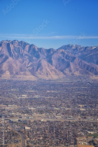 Aerial view of Wasatch Front Rocky Mountain landscapes on flight over Colorado and Utah during winter. Grand sweeping views near the Great Salt Lake, Utah Lake, Provo, Timpanogos, Lone and Twin Peaks 