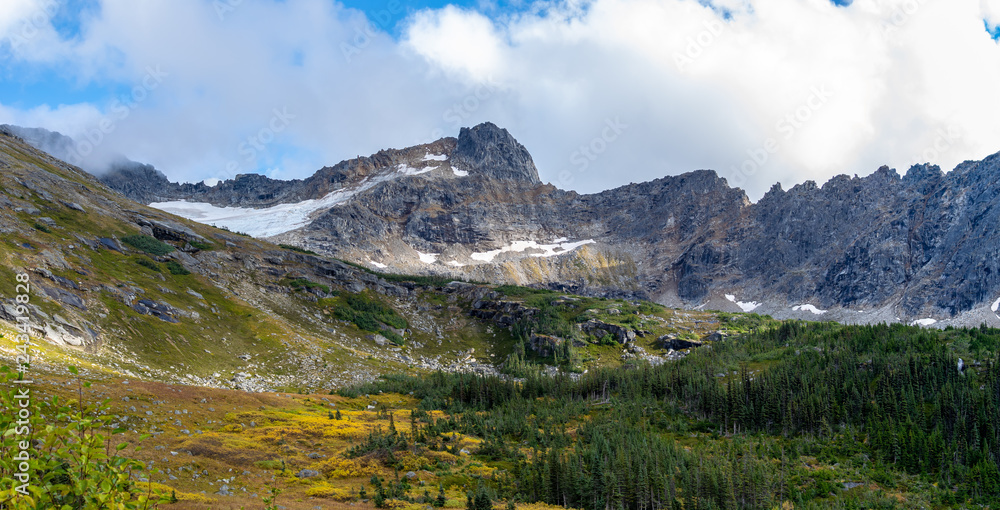 Epic pano landscape view of snow capped mountains and autumn color trees in Upper Dewey Lake, Skagway, Alaska Epic pano landscape view of snow capped mountains and autumn color trees in Upper Dewey Lake, Skagway, Alaska
