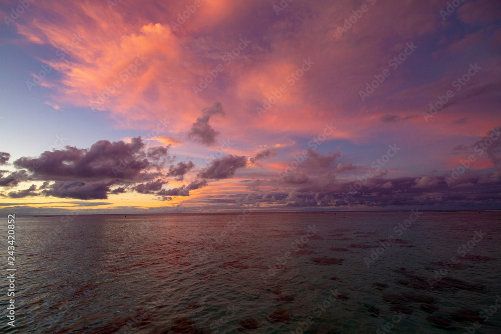 Breathtaking pink sunset over the ocean, seen from over the water bungalow in Moorea, French Polynesia