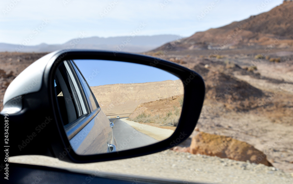 side view mirror of a car , on road inauto,automobile,back,background,behind,blue,car,desert,drive,highway,landscape,looking,mirror,motion,nature,outdoor,rear,reflection,road,route,side,sky the desert