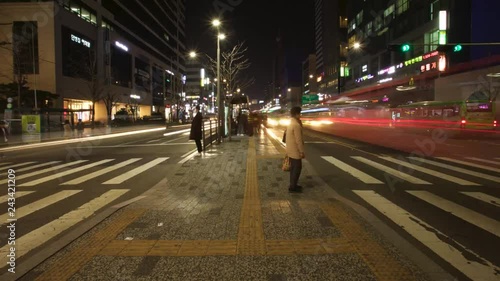 Time Lapse of People Going Home on Crowded Downtown Seoul Street with Busy Night Traffic in City photo