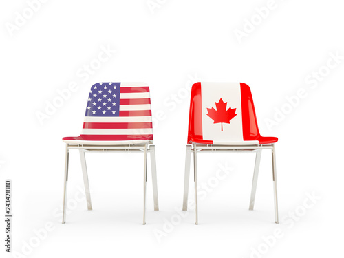 Two chairs with flags of US and canada isolated on white