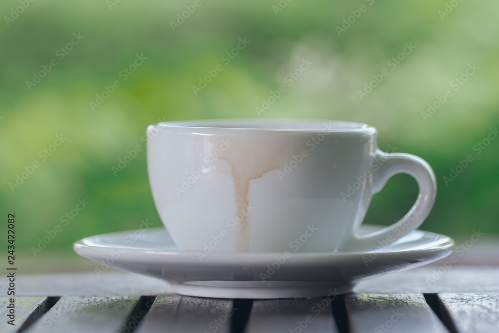 Drinking coffee in morning light. Coffee Cup on wooden background. Drinking coffee in morning light. Coffee Cup on wooden background.