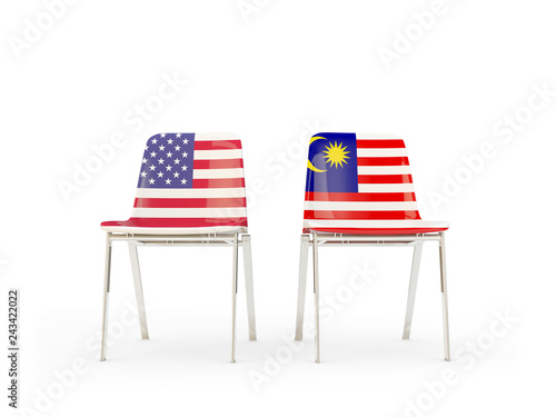 Two chairs with flags of US and malaysia isolated on white