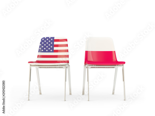 Two chairs with flags of US and poland isolated on white