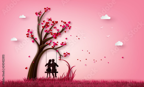 Couple on tree swing in pink blossom world
