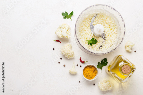 Raw Cauliflower ground in blender bowl. Healthy food background