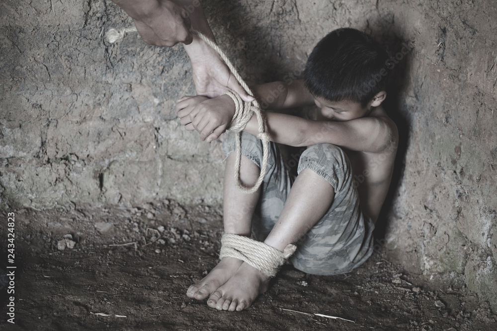 The child is bound by a rope, Stop Child Violence and Trafficking. Stop Violence Against Children, child bondage, Human Rights Day concept.